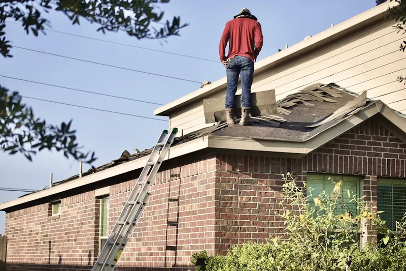 Professional roofer working on a residential roof in Briarwood